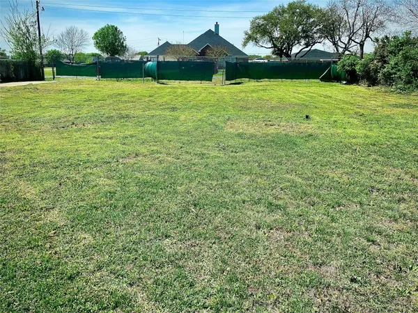 a view of a garden with a house in the background