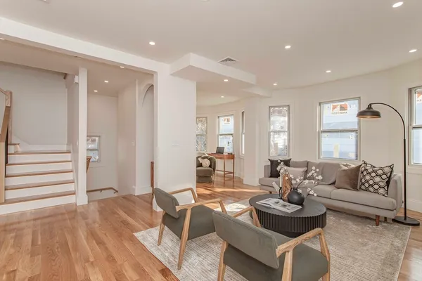 a living room with furniture and wooden floor