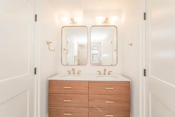 a bathroom with a double vanity sink and mirror
