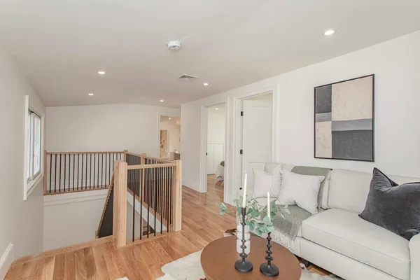 a living room with furniture and a wooden floor