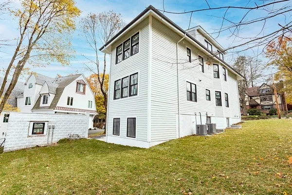 a view of a big house with a yard