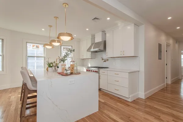 a kitchen with white cabinets and counter space