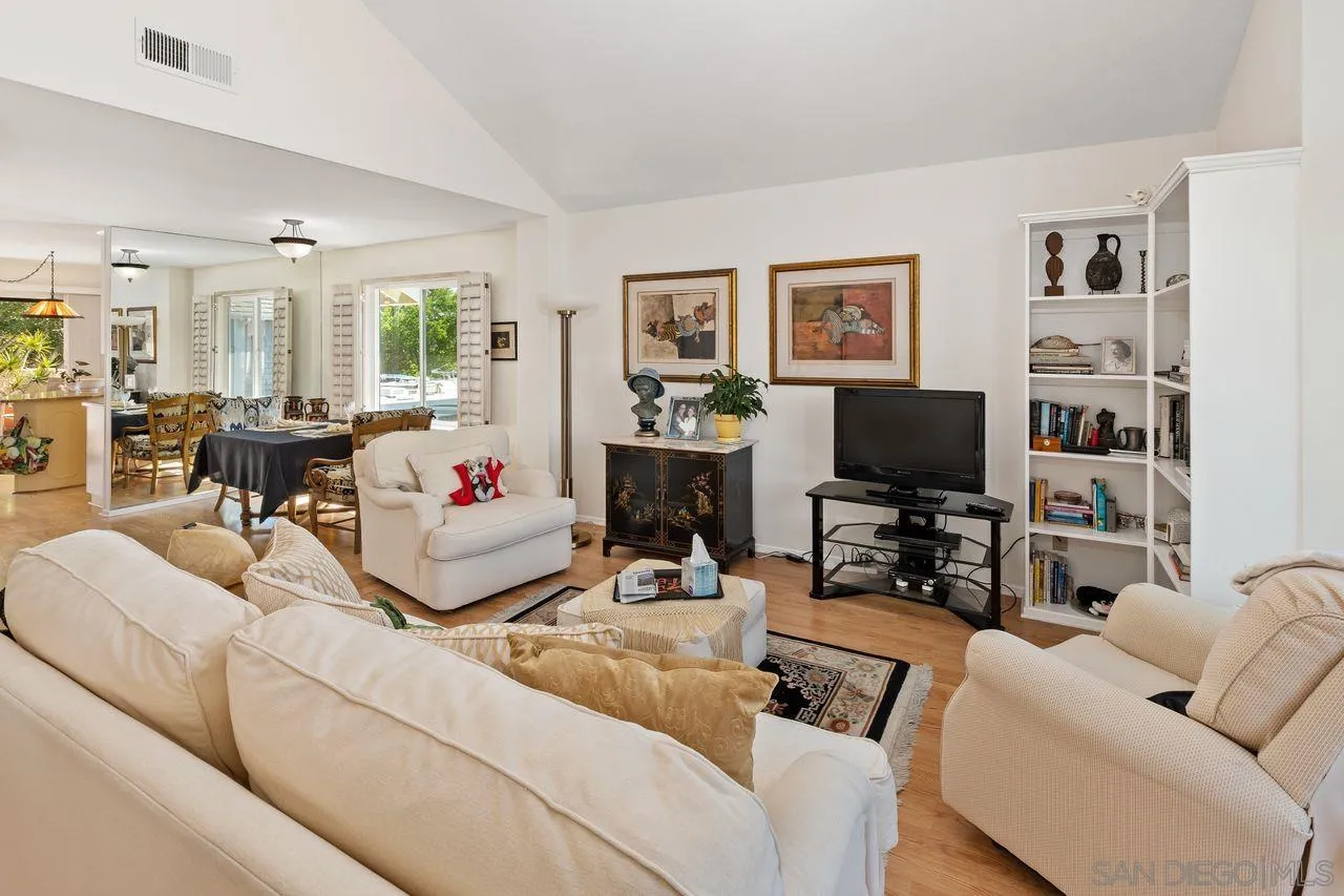 839 Mistletoe Lane Carlsbad, CA 92011 - Photo 13 of 50 a living room with furniture a flat screen tv and a large window