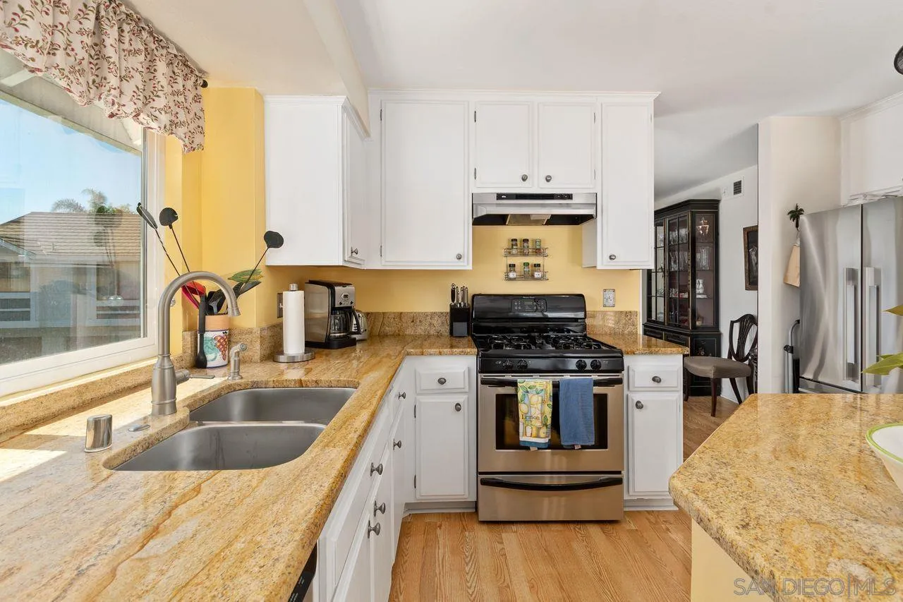 839 Mistletoe Lane Carlsbad, CA 92011 - Photo 15 of 50 a kitchen with a stove a sink and a refrigerator