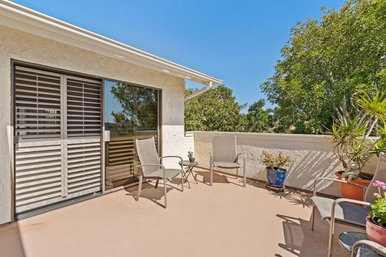839 Mistletoe Lane Carlsbad, CA 92011 - Photo 6 of 50 a view of a patio with a table and chairs and potted plants