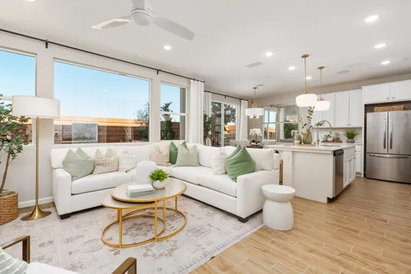 a living room with furniture kitchen view and a refrigerator