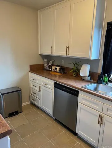 a kitchen with granite countertop a sink and a stove