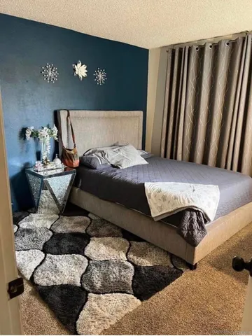 a bedroom with a bed and lamp