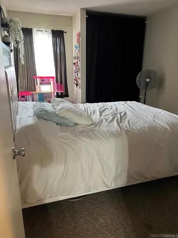 a bedroom with a bed and a flat tv screen