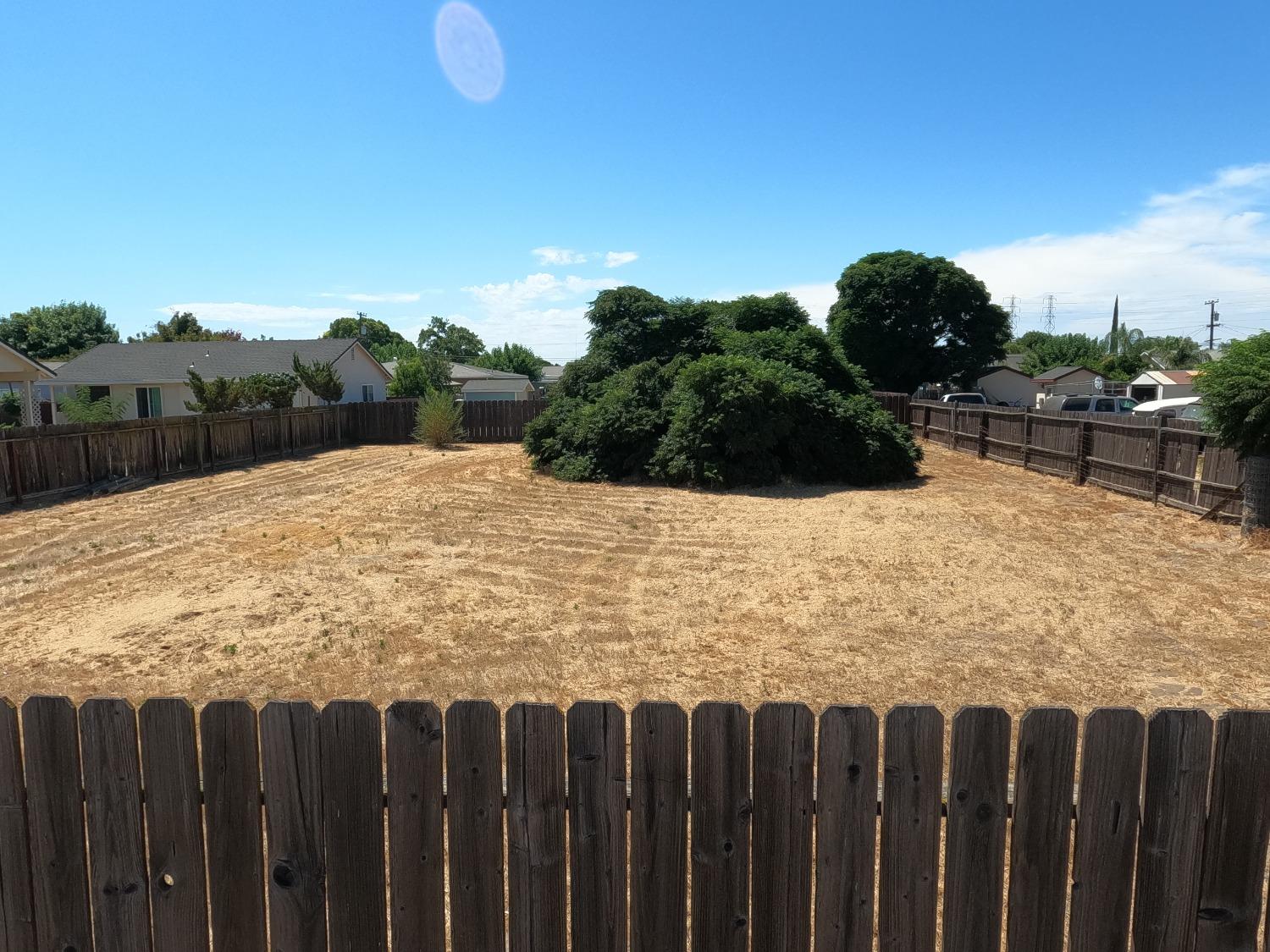 a view of wooden fence next to a yard