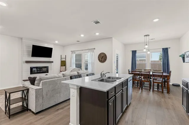 a living room with stainless steel appliances granite countertop furniture and a kitchen view