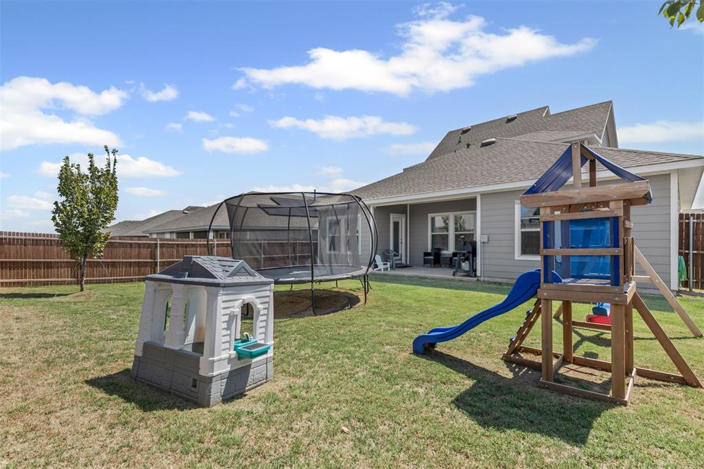 752 Amelia Court Pilot Point, TX 76258 - Photo 16 of 35 a view of a house with backyard water fountain and sitting area