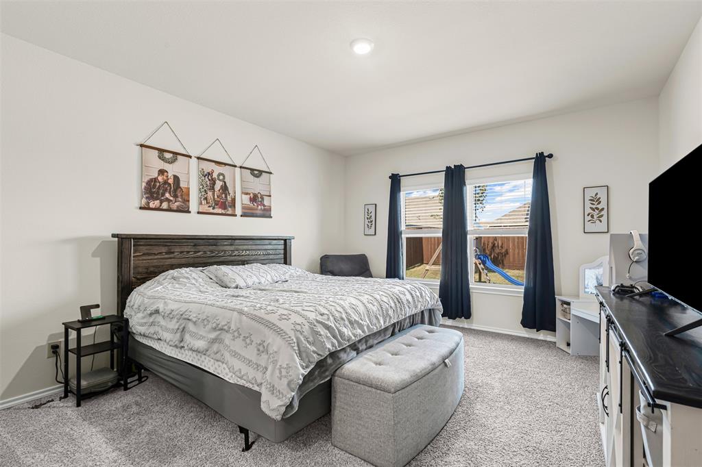 752 Amelia Court Pilot Point, TX 76258 - Photo 20 of 35 a bedroom with a bed and a flat screen tv
