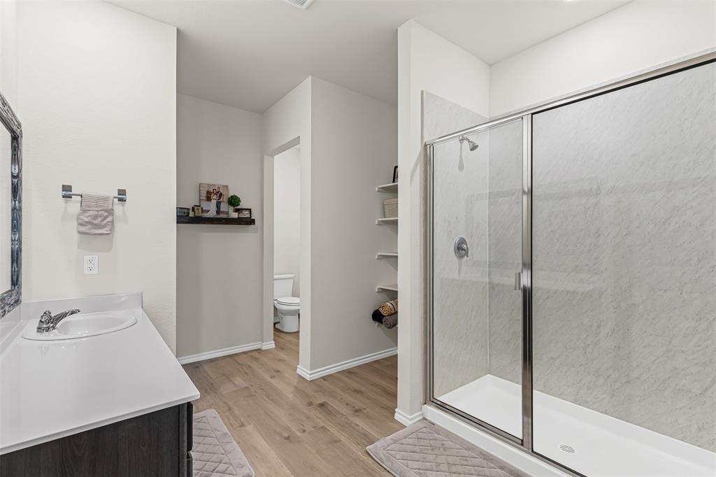 752 Amelia Court Pilot Point, TX 76258 - Photo 22 of 35 a bathroom with a sink and shower