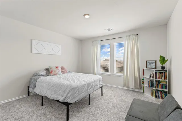 a living room with furniture and a book shelf