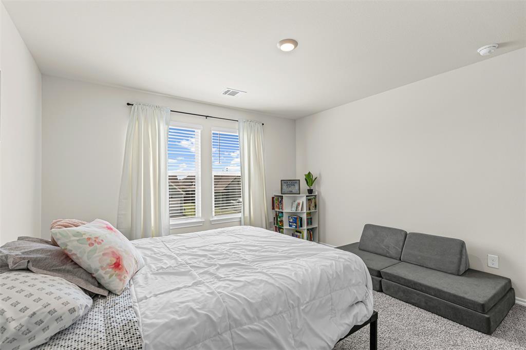 752 Amelia Court Pilot Point, TX 76258 - Photo 30 of 35 a bedroom with a bed and a couch