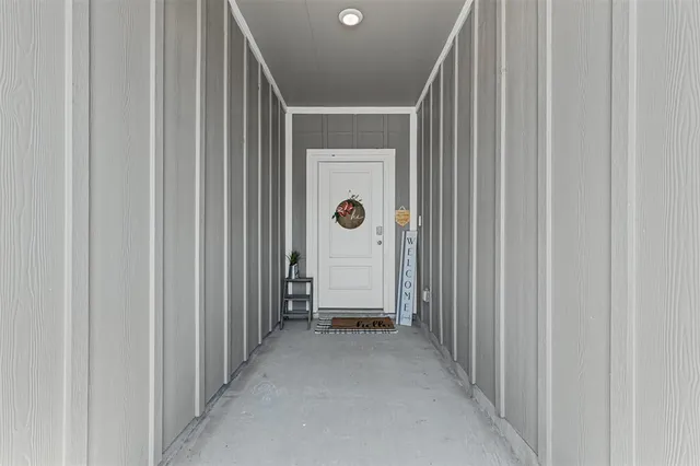 a view of a hallway with wooden shelves