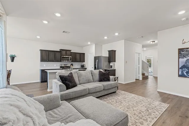 a living room with furniture and kitchen view
