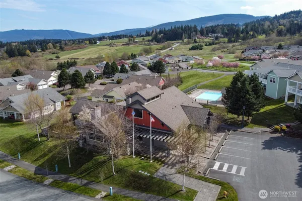 swimming pool view with a seating space and barbeque grill