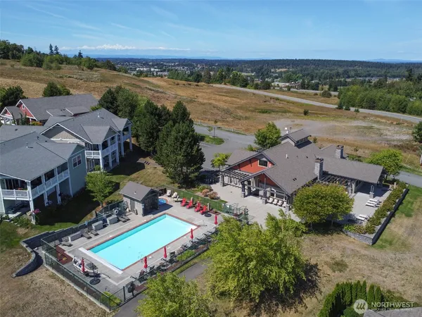 an aerial view of a city with lots of residential buildings and ocean view