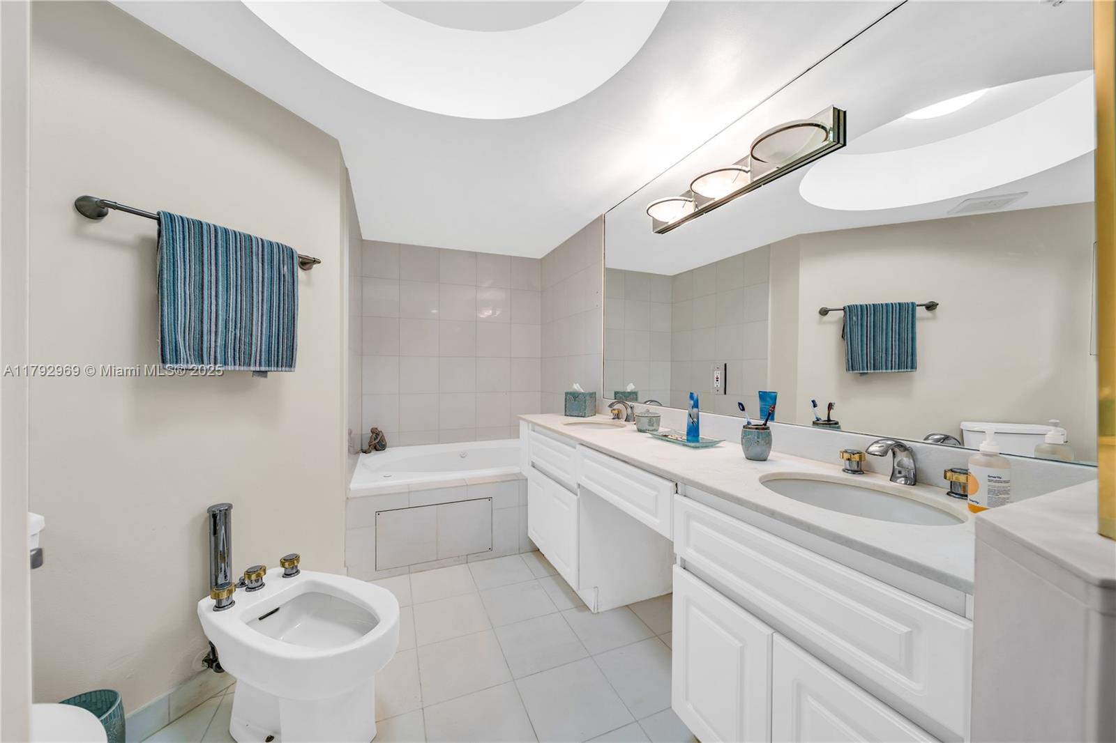 6301 Collins Avenue, Unit 1708 Miami Beach, FL 33141 - Photo 15 of 43 a bathroom with a sink a toilet and a mirror