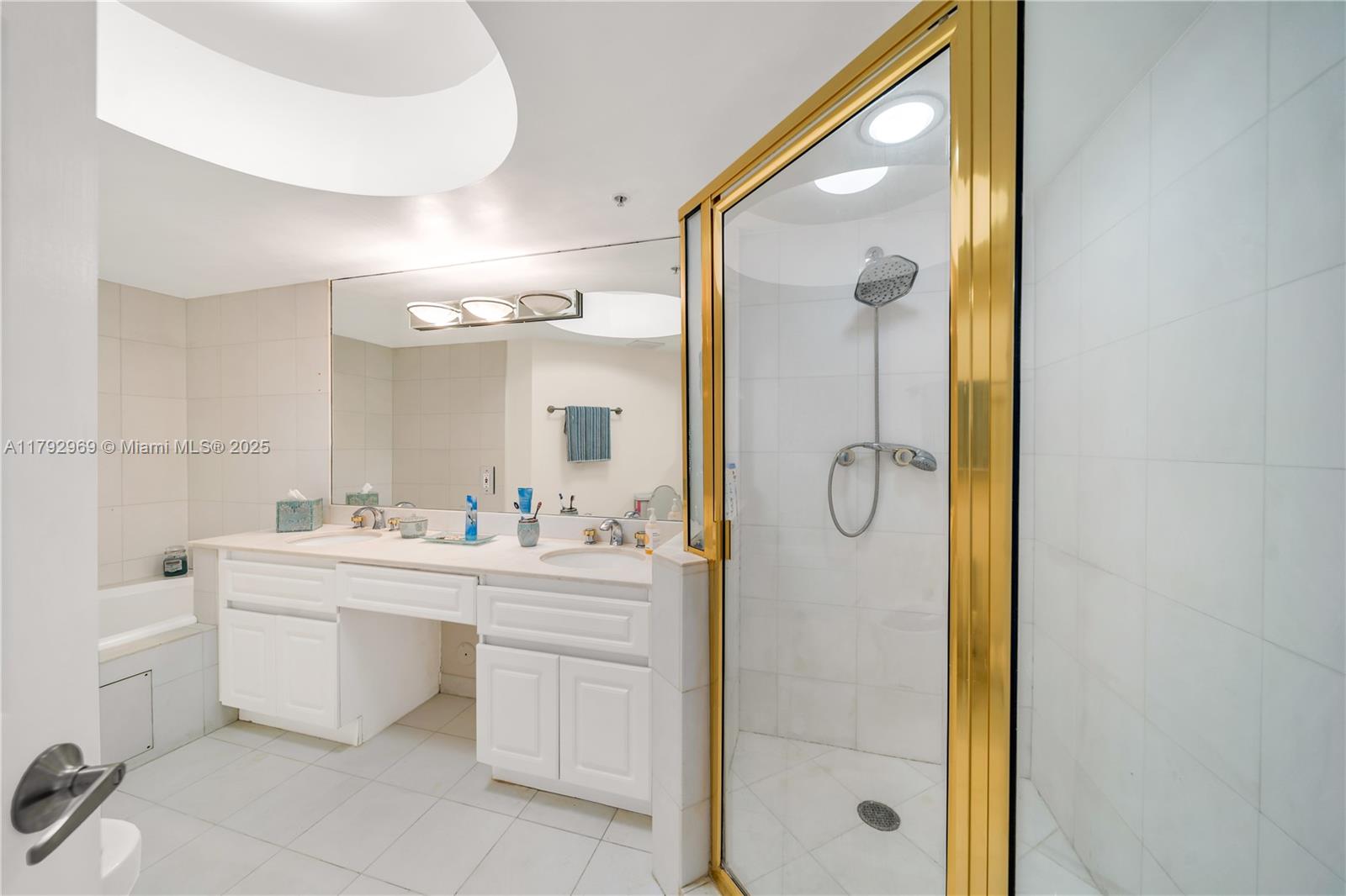 6301 Collins Avenue, Unit 1708 Miami Beach, FL 33141 - Photo 19 of 43 a bathroom with a double vanity sink mirror bathtub shower and toilet
