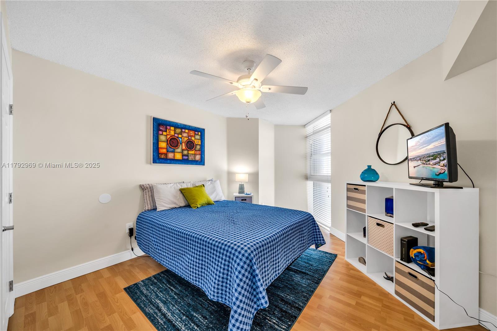 6301 Collins Avenue, Unit 1708 Miami Beach, FL 33141 - Photo 20 of 43 a bedroom with a bed and a book shelf