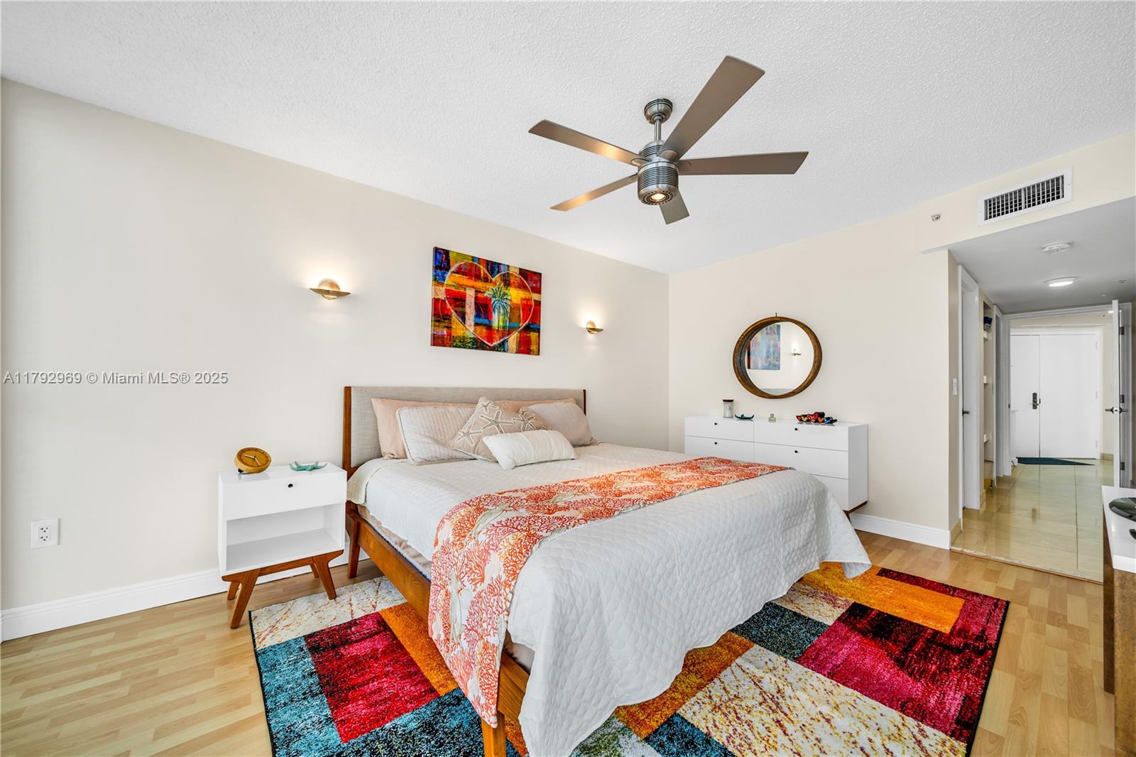 6301 Collins Avenue, Unit 1708 Miami Beach, FL 33141 - Photo 22 of 43 a bedroom with a bed and dresser