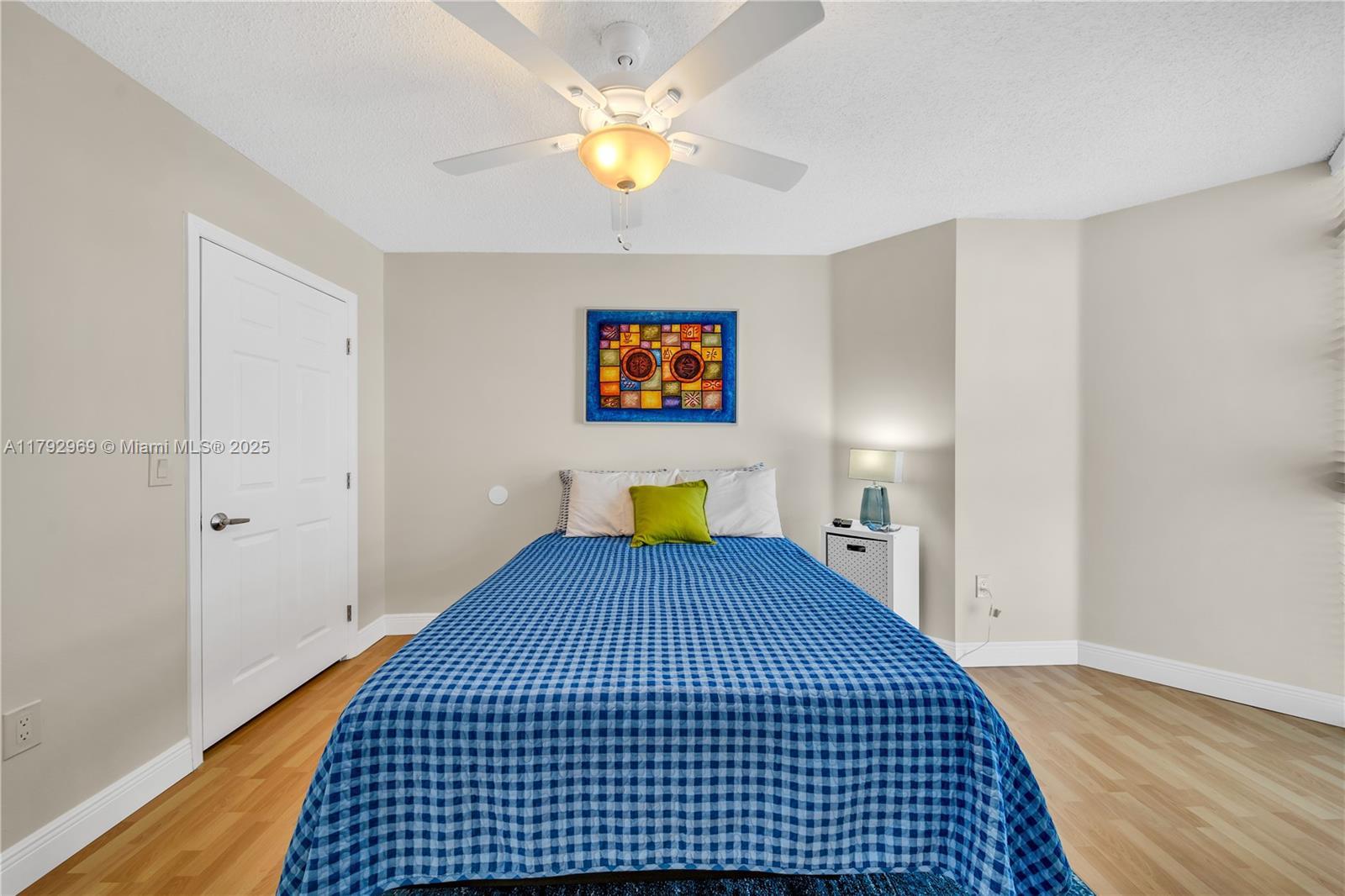 6301 Collins Avenue, Unit 1708 Miami Beach, FL 33141 - Photo 29 of 43 a bedroom with a bed and a chandelier