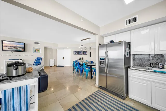 a kitchen with refrigerator cabinets and a center island