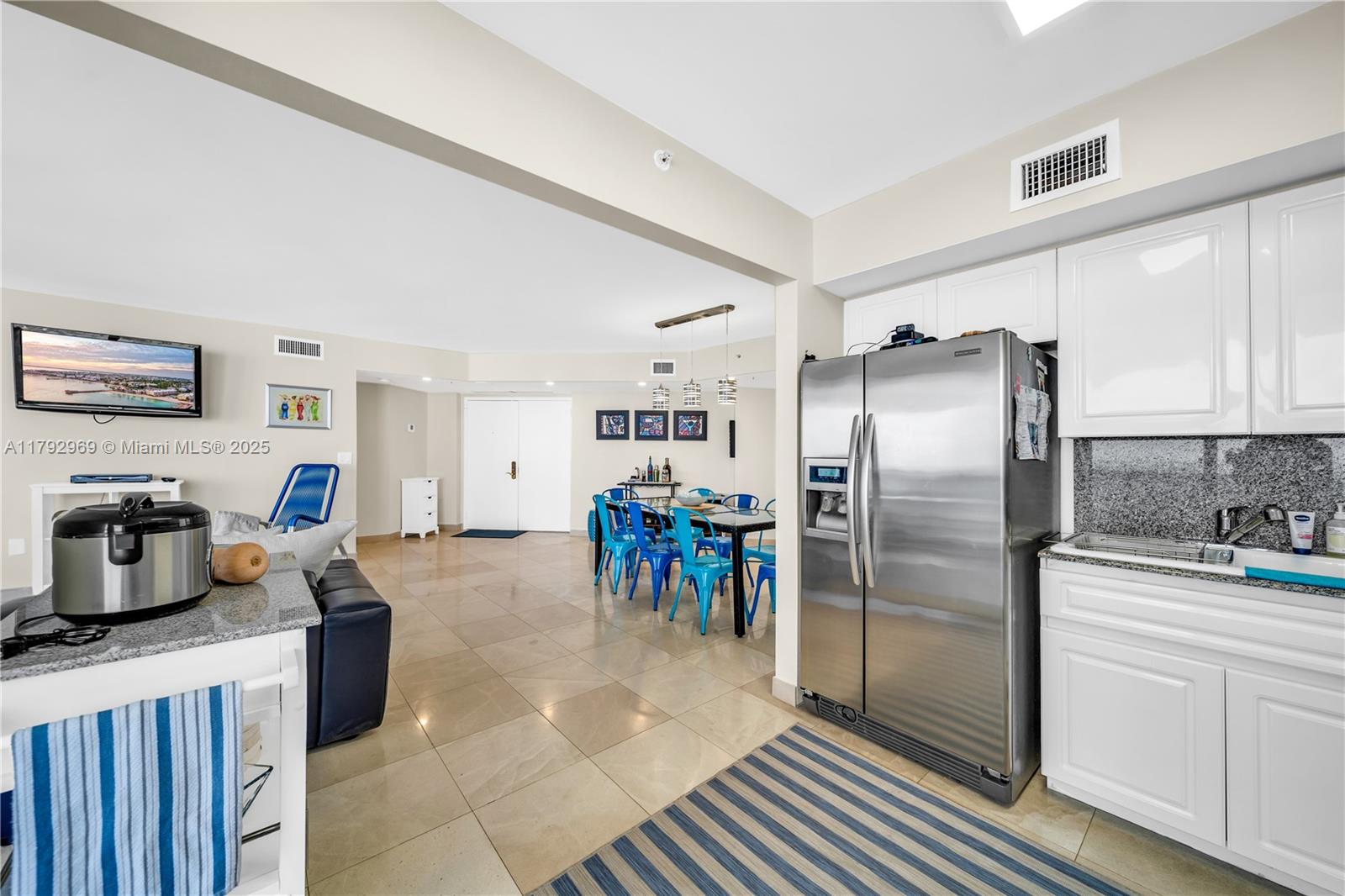 6301 Collins Avenue, Unit 1708 Miami Beach, FL 33141 - Photo 3 of 43 a kitchen with refrigerator cabinets and a center island