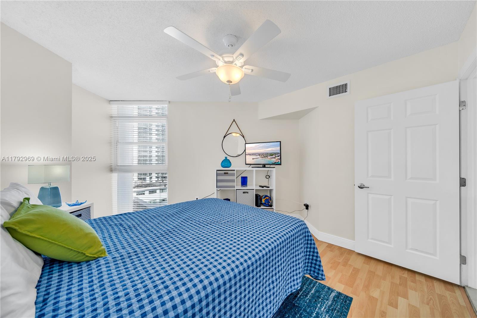 6301 Collins Avenue, Unit 1708 Miami Beach, FL 33141 - Photo 31 of 43 a bedroom with a bed and a chandelier