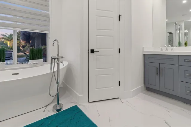 a bathroom with a sink a toilet and bathtub