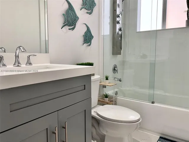 a bedroom with a bed and flat screen tv