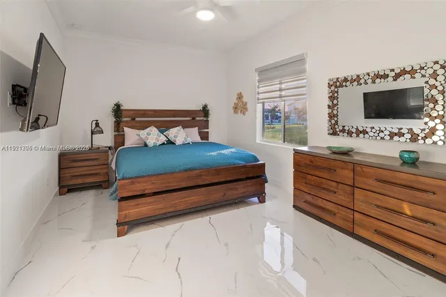 a bathroom with a sink a toilet a glass door and shower