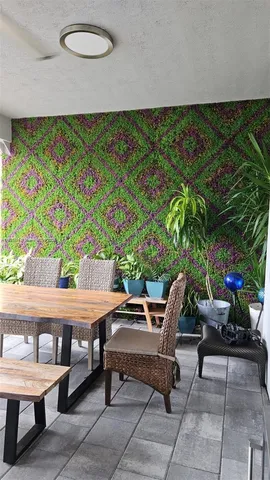 a view of a porch with dining table and chairs