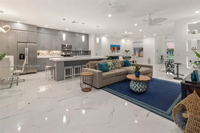 a living room with furniture a kitchen view and a kitchen view