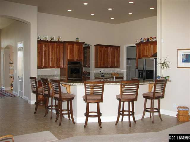 135 Gazelle Road Reno, NV 89511 - Photo 5 of 13 a kitchen with stainless steel appliances kitchen island granite countertop a table and chairs
