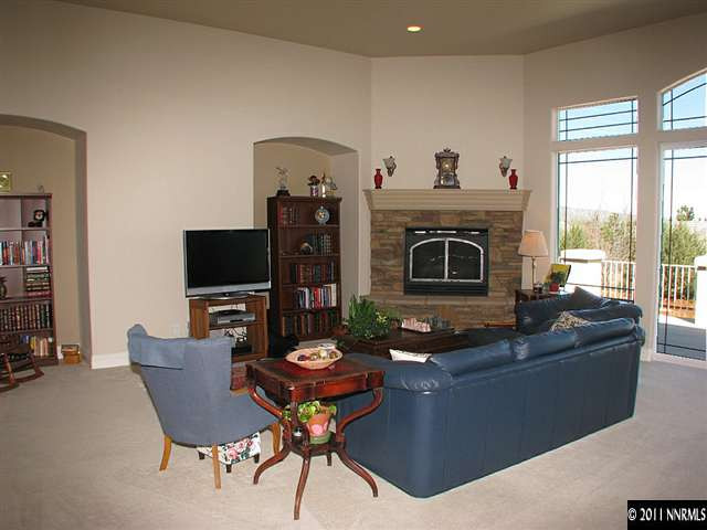 135 Gazelle Road Reno, NV 89511 - Photo 8 of 13 a living room with furniture a fireplace and a flat screen tv