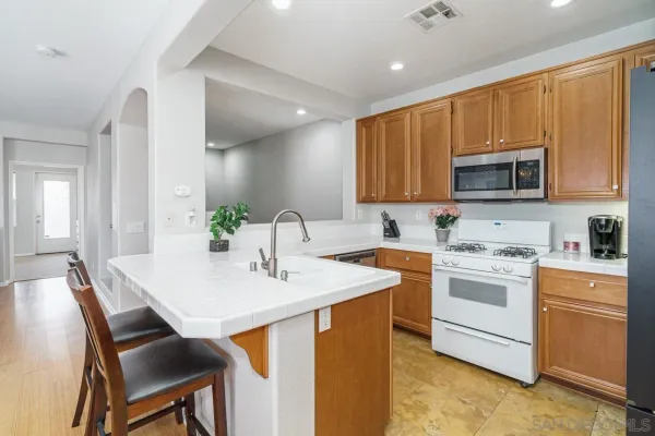 a kitchen with a stove a sink and a microwave