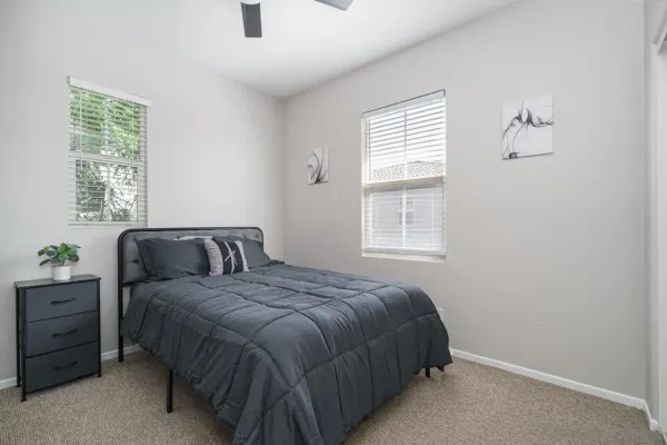 a bedroom with a bed and a window