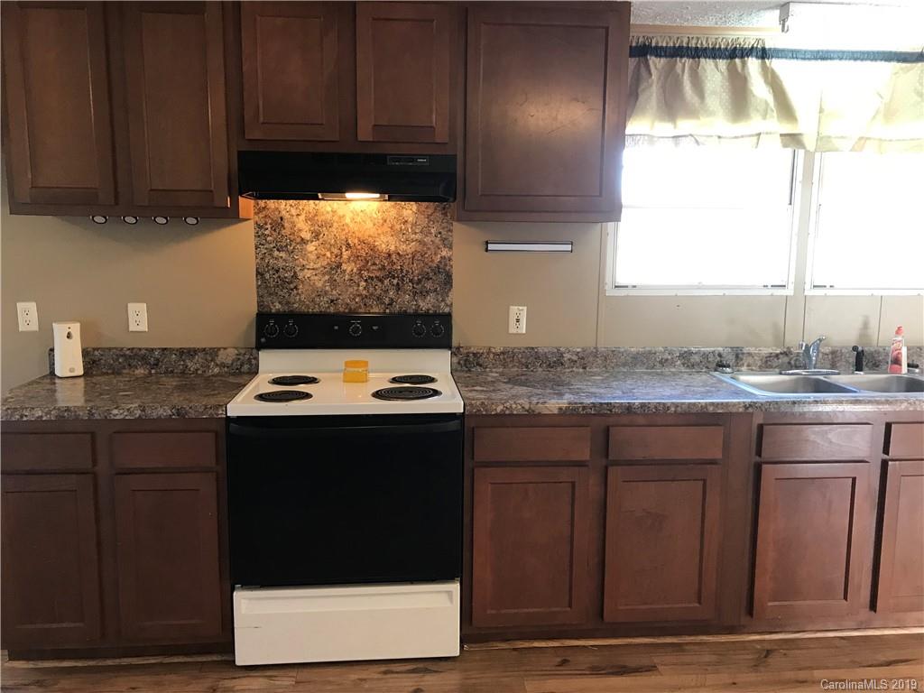 124 Fair Share Road Salisbury, NC 28147 - Photo 15 of 33 a kitchen with granite countertop a sink cabinets and a stove