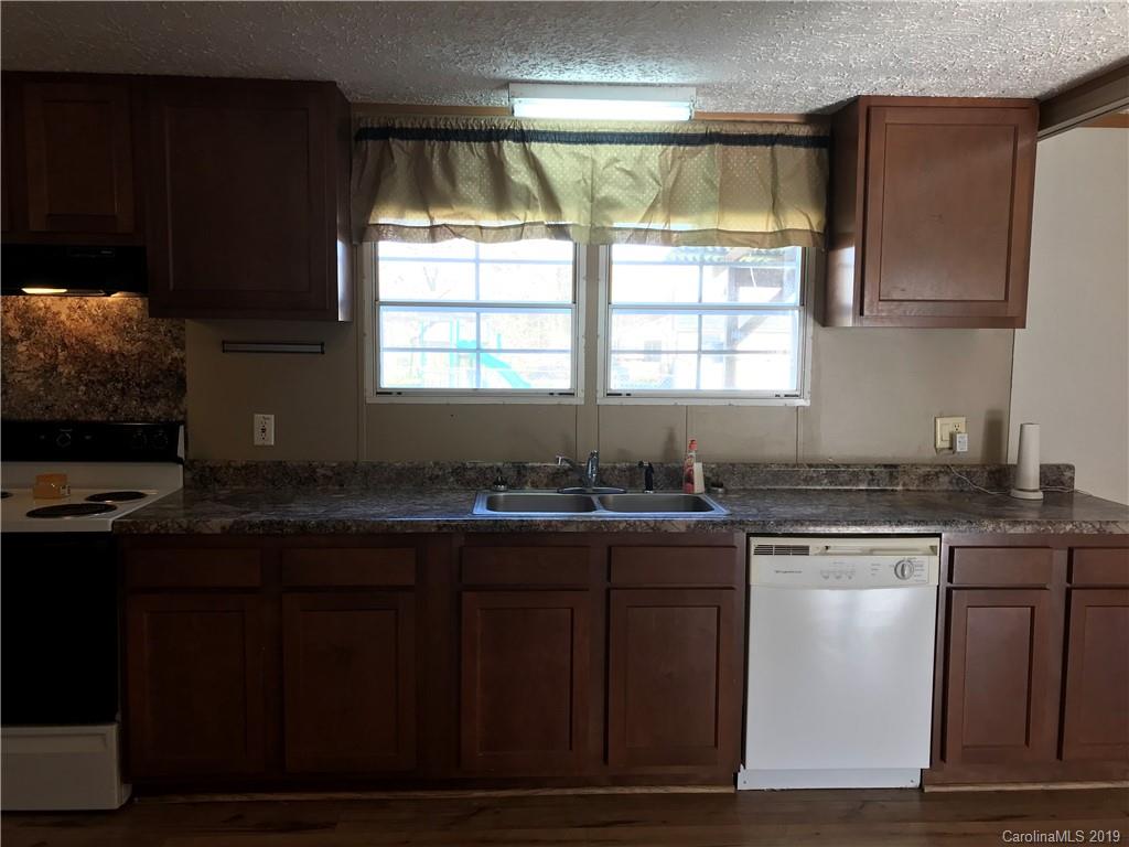 124 Fair Share Road Salisbury, NC 28147 - Photo 16 of 33 a kitchen with granite countertop cabinets a sink and appliances