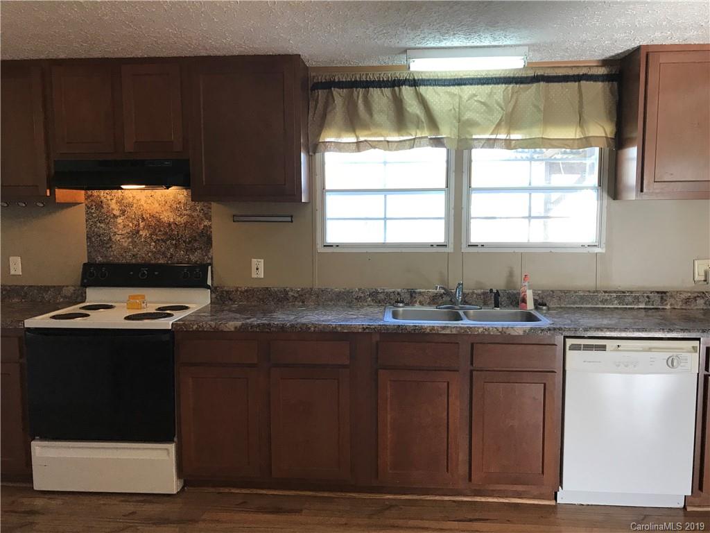 124 Fair Share Road Salisbury, NC 28147 - Photo 17 of 33 a kitchen with stainless steel appliances granite countertop wooden cabinets a sink and a stove