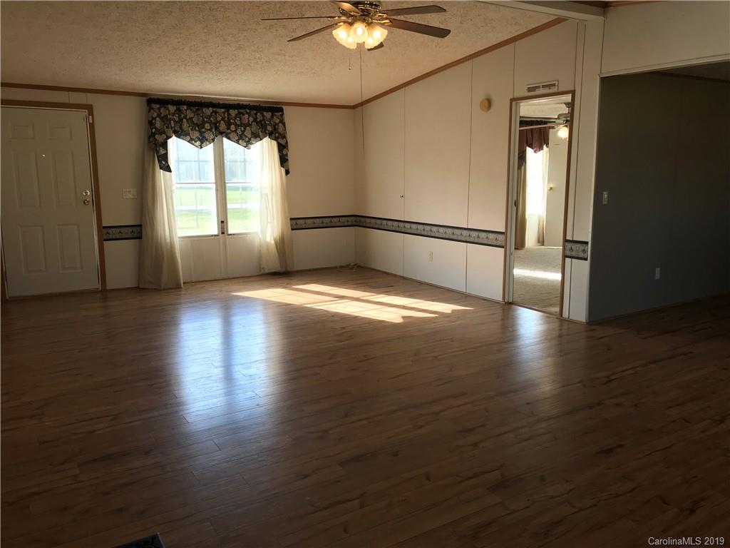 124 Fair Share Road Salisbury, NC 28147 - Photo 23 of 33 an empty room with wooden floor and windows