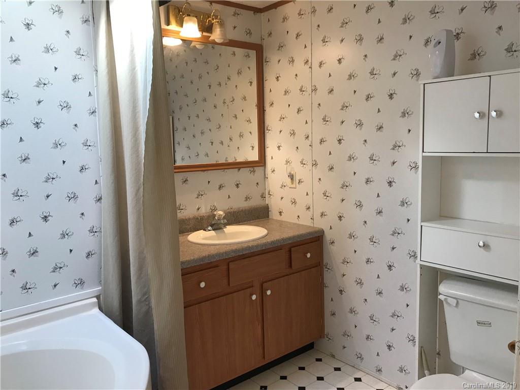 124 Fair Share Road Salisbury, NC 28147 - Photo 30 of 33 a bathroom with a granite countertop sink a toilet and a shower