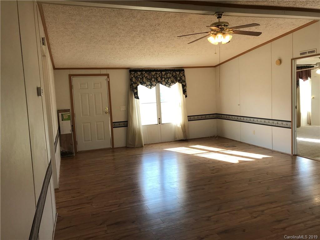 124 Fair Share Road Salisbury, NC 28147 - Photo 5 of 33 an empty room with wooden floor and windows