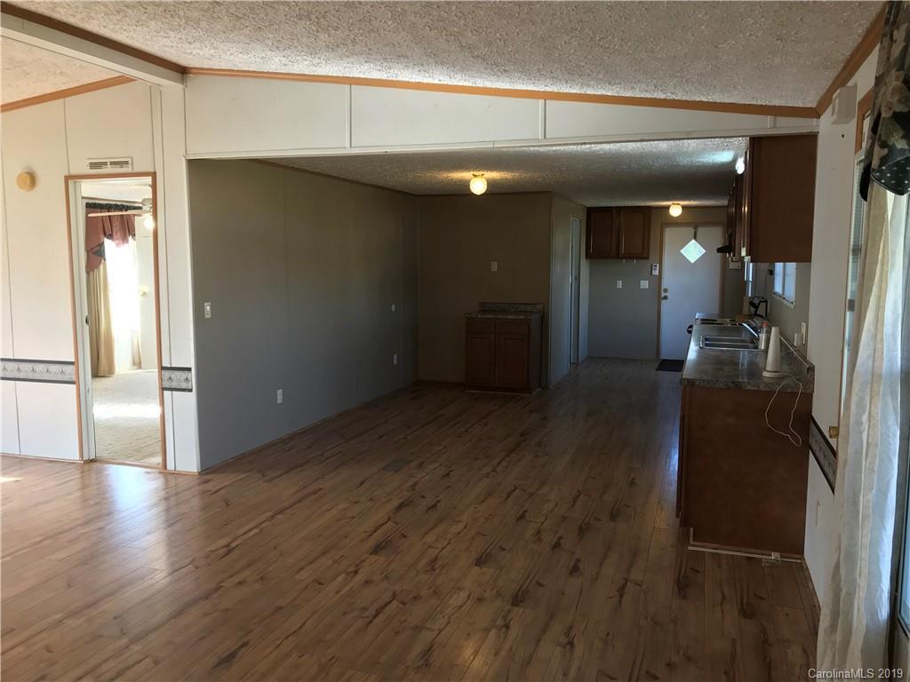 124 Fair Share Road Salisbury, NC 28147 - Photo 9 of 33 a view of a hallway with wooden floor