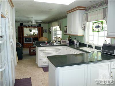 1142 Hendrix Avenue Thousand Oaks, CA 91360 - Photo 6 of 10 a kitchen with a stove a sink and a refrigerator