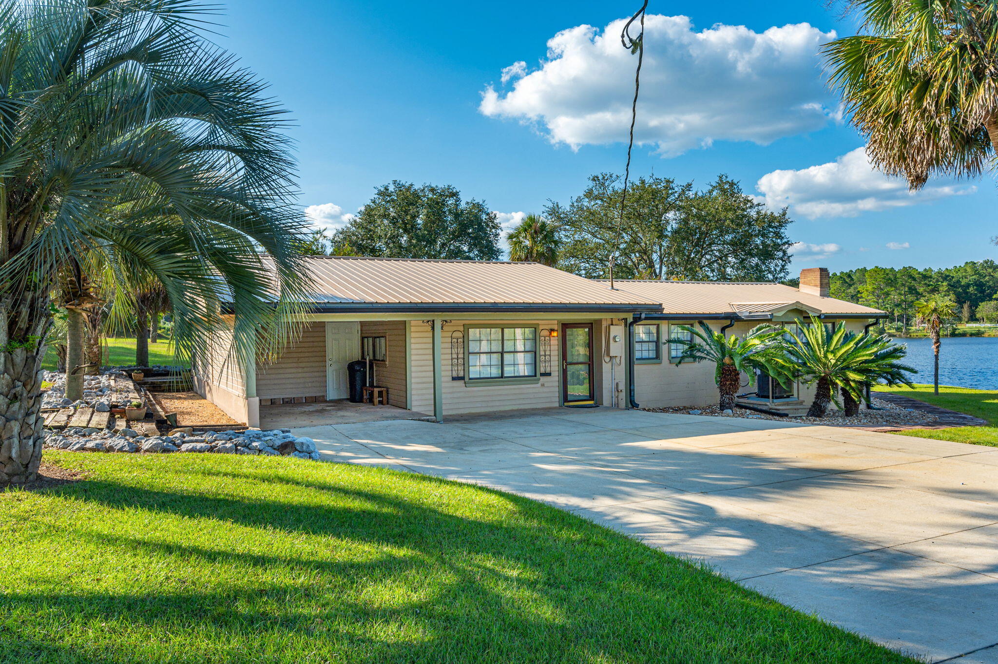 7068 Old River Road Baker, FL 32531 - Photo 11 of 42 a view of a house with swimming pool and sitting area